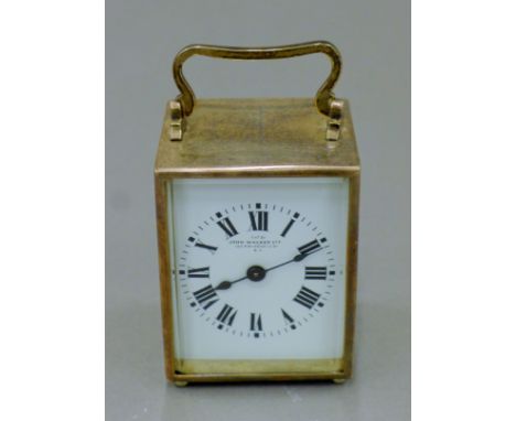 A John Walker desk clock in a white metal case. 10 cm high.