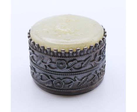 A jade-topped pill box.  4 cm diameter.