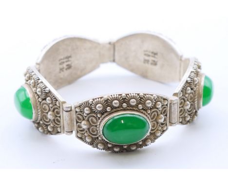 A Chinese jade set bracelet.  19 cm long, each link 2.25 cm high x 3.5 cm.