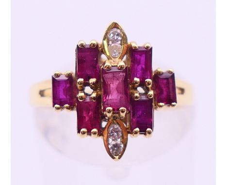 An 18 ct gold, ruby and diamond cluster ring. Ring size M/N. 3.9 grammes total weight.