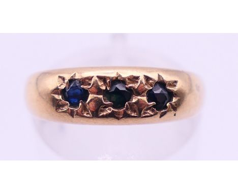 A 9 ct gold gypsy-set sapphire ring. Ring size N. 
