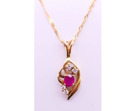 An 18 ct ruby and diamond pendant on an 18 ct gold chain.  Pendant 2.5 cm high, chain 44 cm long. 3.6 grammes total weight. 