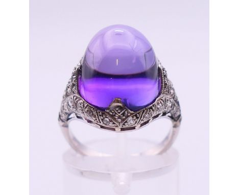 An Art Deco palladium, platinum and amethyst ring. Ring size L.