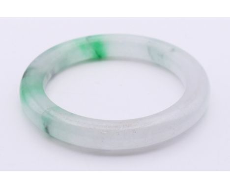 A two-tone icy jade bangle.  5 cm internal diameter, 6.5 cm external diameter, approximately 0.75 cm wide. 