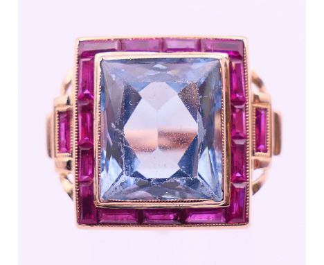 An 18 K gold, aquamarine and ruby Art Deco style ring.  Square setting 1.75 cm x 1.5 cm. Ring size L. 
