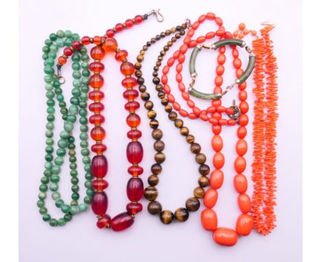 A quantity of bead necklaces, including jade, tiger's eye and a jade bracelet.  Jade necklace 84 cm long.