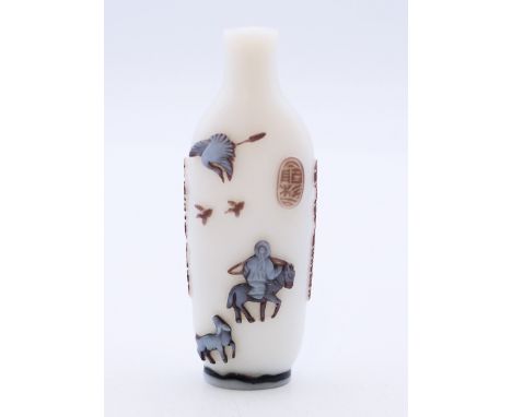 A Chinese glass snuff bottle of overlaid colours predominantly white, carved with fishing scene and calligraphy. 9 cm high.