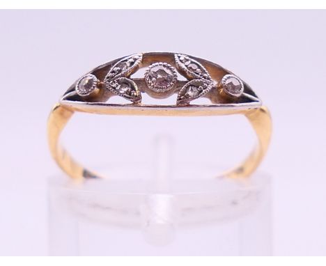 An 18 ct gold and diamond floral ring. Ring size L. 1.8 grammes total weight.