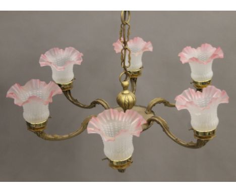 A brass six-branch chandelier. 72 cm wide.