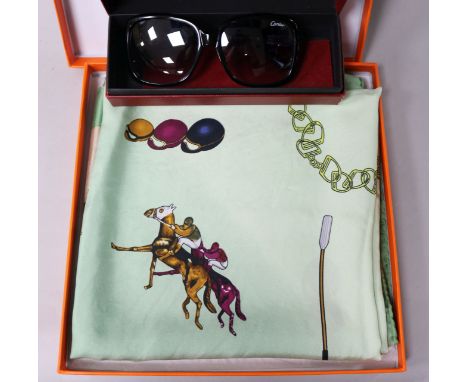 A pair of Cartier sunglasses and a Hermes scarf