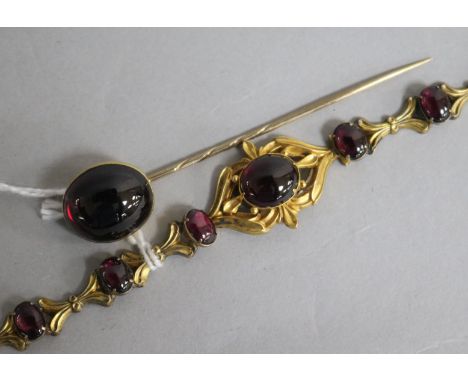 A Victorian gold and cabochon almandine garnet set bracelet and a similar stick pin.