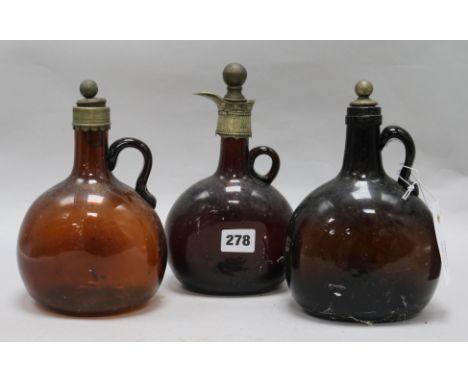 Three Victorian amber glass decanter flagons