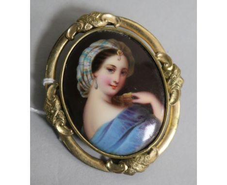 A late 19th century pinchbeck mounted oval porcelain portrait miniature, 62mm.