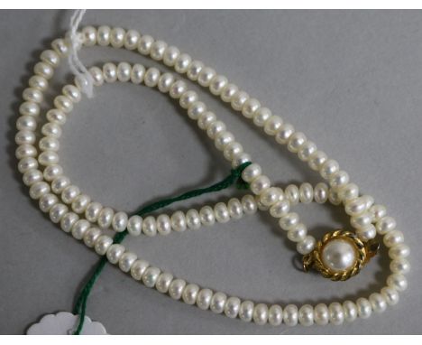 A single strand cultured pearl necklace, with gilt metal clasp, 41cm.