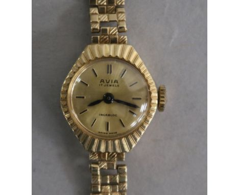 A lady's 9ct gold Avia manual wind wrist watch on a 9ct gold bracelet.