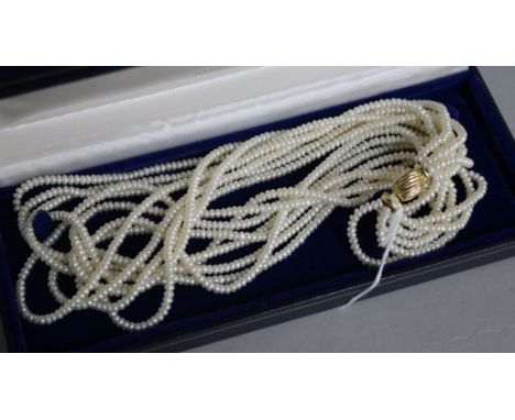 A multi strand seed pearl necklace with 14ct gold clasp, with Mikimoto box, 44cm.