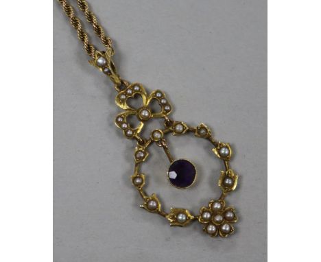 An Edwardian 9ct gold seed pearl and amethyst pendant and yellow metal rope twist chain, pendant 5cm.