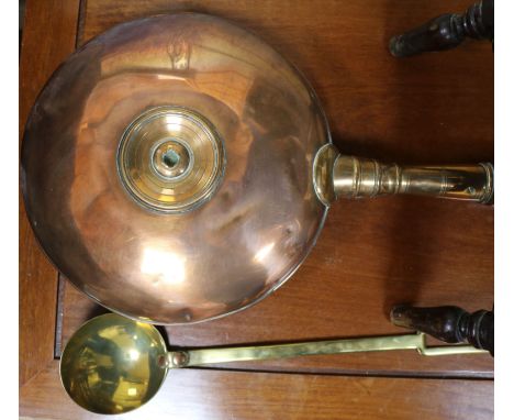 A Victorian copper warming pan and a brass ladle