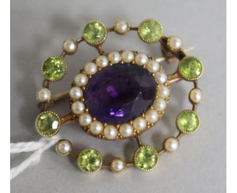 An Edwardian 15ct gold amethyst, peridot and pearl openwork brooch, in the suffragette colours, 28mm.