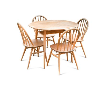An Ercol elm dining and four chairs,the circular top on four tapering supports with undertier the table 72 x 88cm