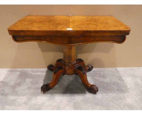 A Victorian burr walnut flip over top Card table, rounded rectangular hinged top over a moulded edge shaped frieze, supported