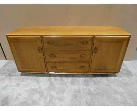 A mid/late 1970's Ercol light ash sideboard, rectangular top over three central drawers, the top drawer housing a cutlery tra