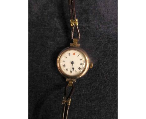A Ladies 9ct gold Wrist Watch with white enamel face, G Marsden, Darwen, on leather strap, 30mm diameter, 21g gross 