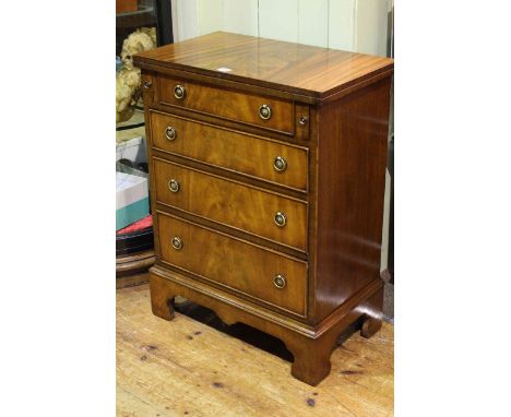 Bevan Funnell Reprodux mahogany bachelors chest having fold top above four drawers on shaped bracket feet