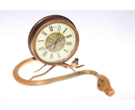 Wooden articulated model of a serpent and mantel clock