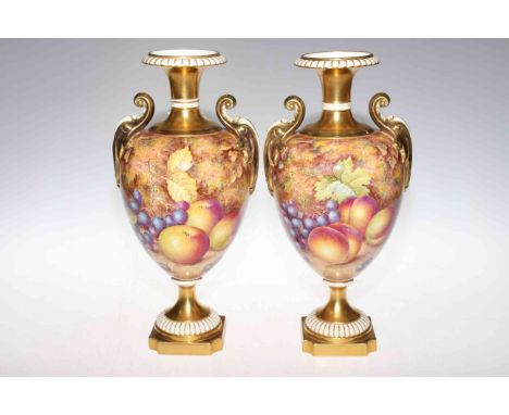 Pair of Royal Worcester two handled fruit painted pedestal vases, signed Freeman, 31.5cm high