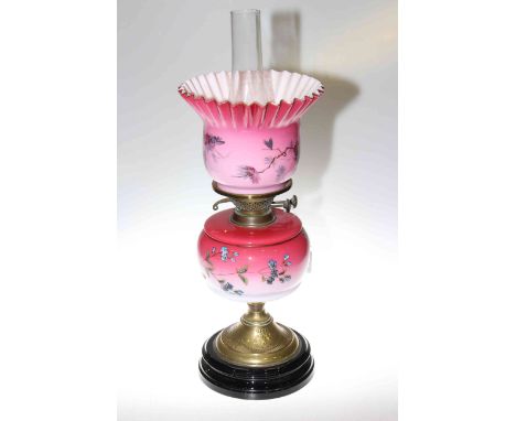 Victorian brass oil lamp with floral decorated pink reservoir and shade