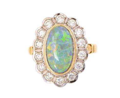 An opal and diamond cluster ring, the oval opal measuring 13.0 x 7.7 x 3.3mm, in collet setting, surrounded by fourteen brill