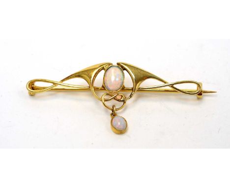 Murrle Bennett &amp; Co: an opal and yellow metal brooch, the Art Nouveau whiplash design with central oval opal cabochon mea