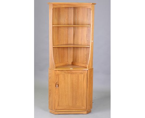 A Ercol elm corner unit, fitted with shelves above a cupboard, height 180cm, width 74cm.Buyer’s Premium 29.4% (including VAT 