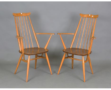A pair of Ercol beech and elm Windsor type elbow chairs, height 98cm, width 62cm.Buyer’s Premium 29.4% (including VAT @ 20%) 