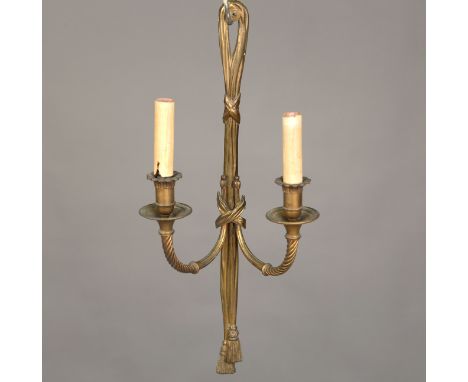 A set of four 20th century Neoclassical Revival cast brass twin-light wall sconces with ribbon tied backplates issuing two sp