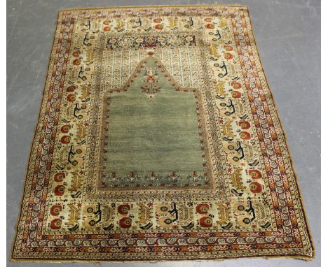 A Kayseri silk prayer rug, late 19th century, the jade green mihrab with hanging lantern, within an ivory fruiting vine and s