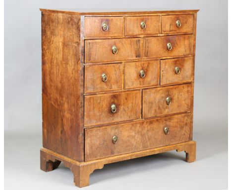 An 18th century style walnut chest of oak-lined drawers with overall feather and crossbanded borders, raised on bracket feet,