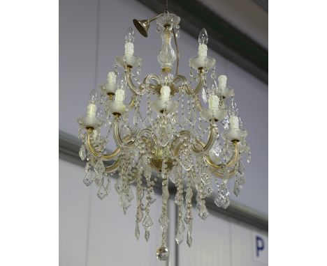 A mid-20th century moulded and cut glass mounted two-tier fourteen-light chandelier, hung with multiple lozenge drops, height