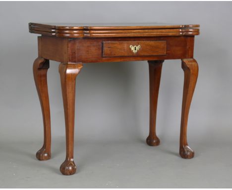 A mid-18th century mahogany fold-over triple-hinged games table, possibly American, the top with projecting corners and hinge