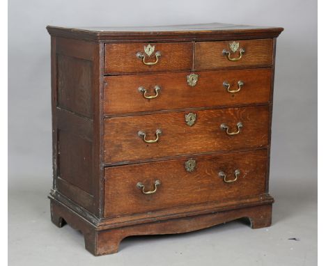 An early 18th century oak chest, the top with a moulded edge and panel sides, fitted with two short and three long drawers, o
