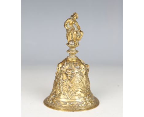 A late 19th century Continental gilt brass bell, cast with figural handle over a body relief cast with a stag-hunting scene, 