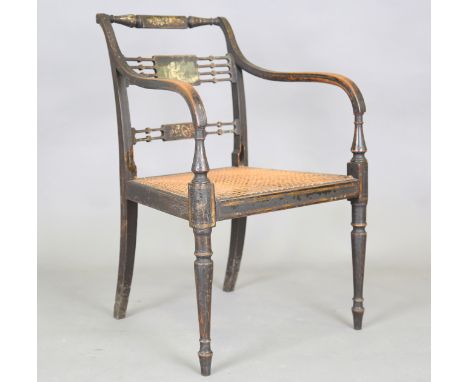 A Regency painted elbow chair, the centre rail decorated with a cherub playing a lyre, the caned seat above turned tapering l