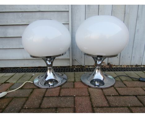 Two Harvey Guzzini globe table lamps designed by Luciano Buttura c1968, white globe shades on chromed tulip bases. Labelled. 