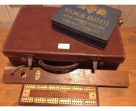 Small leather suitcase with a cribbage board, a Jack spirit level, a stencil set in original tin and a porcupine quill. (5).