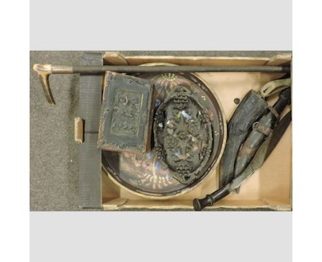 A box of items to include three kukris, a carved wooden caddy, a painted tray and a carving