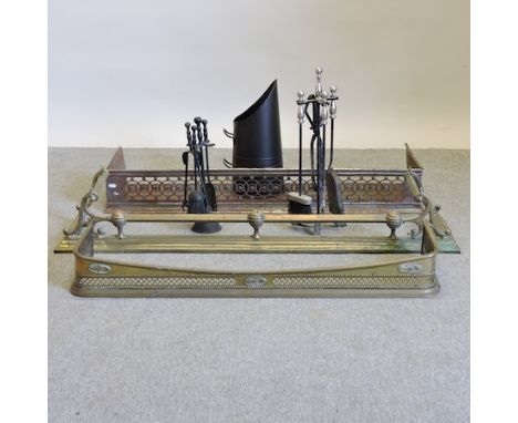 A pierced metal fender, 117cm, together with a brass fender, a set of fire tools, another and a black painted coal scuttle