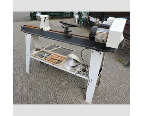 An Axminster woodturning lathe, 117cm tall, together with tools