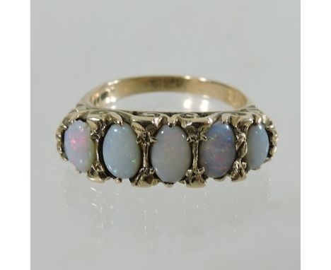 A 9 carat gold and opal five stone ring, with an openwork setting