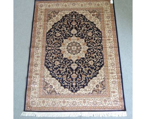 A Keshan carpet, with scrolled designs on a blue field, 230 x 160cm